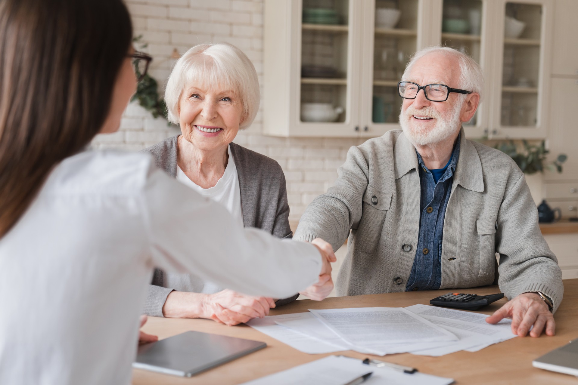 Happy old elderly senior grandparents family couple clients signs financial insurance, pension, startup, dealing handshake agent lawyer, agreement with customers on investment contract, bank manager